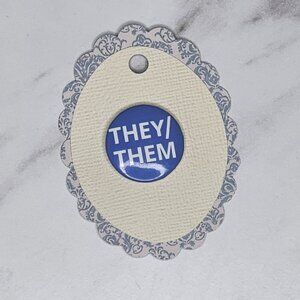 THEY/THEM buttonThis collectible pin is a...